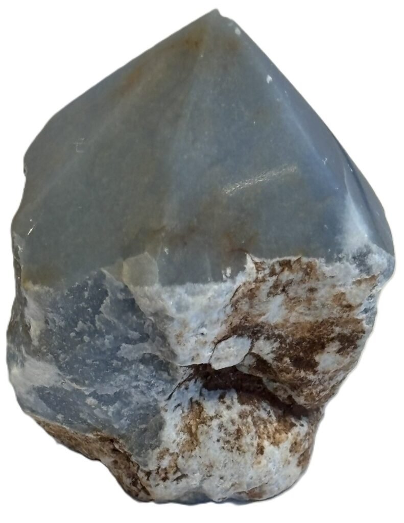Natural rough angelite freeform with polished point 1 sians emporium Natural rough angelite freeform crystal with unpolished sides and a smooth polished blue point standing on a white background
